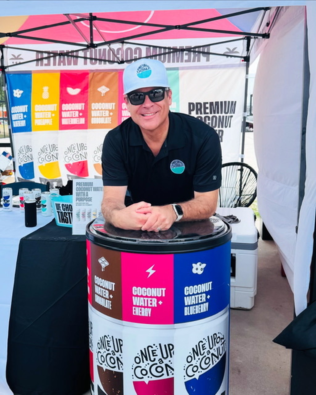 Mark Ellis sampling Once Upon A Coconut coconut water at a field activation